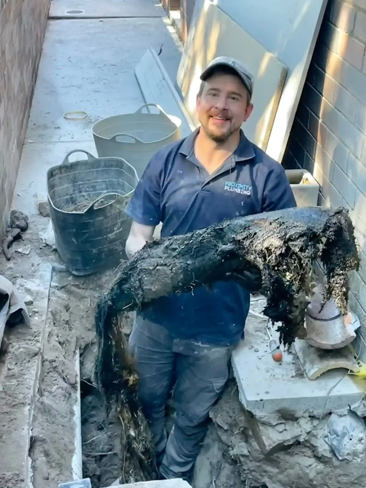 Clearing debris from an excavated drain line